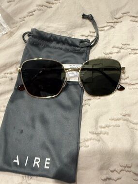 AIRE Women’s Gold Frame Sunglasses with Dark Green Lenses